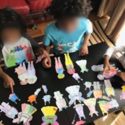 photo of kids playing with the anatomically correct paper dolls