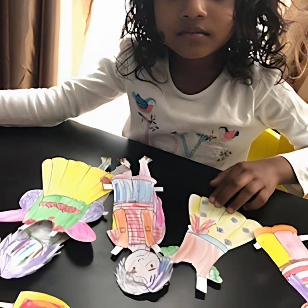 photo of child playing with the anatomically correct paper dolls