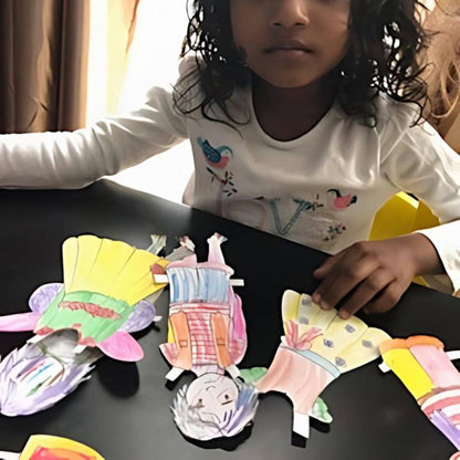 photo of child playing with the anatomically correct paper dolls